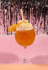 Closeup of a vibrant  fresh cocktail on a surface with a colorful background - obrazy, fototapety, plakaty