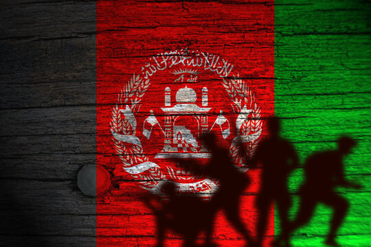 Afganistan flag painting on wood and soldiers shadow