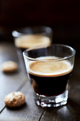 Two Glasses Of Coffee on dark wooden background. Close up.	