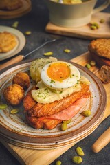 Rustic wooden board with breakfast including toasted bread, mashed potatoes, and boiled eggs