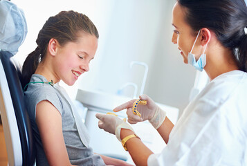 Child, dentist and patient for teeth whitening, oral healthcare and checkup for cleaning with...