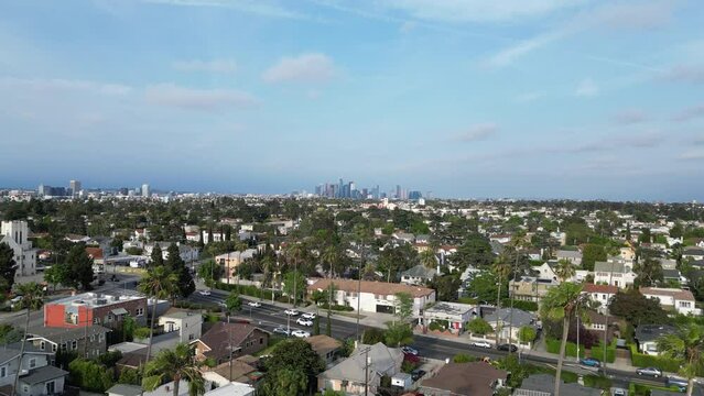 Aerial footage flying over South Central Los Angeles with Downtown in the background in California