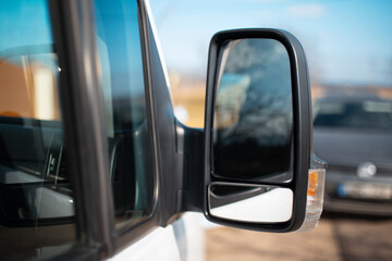 Close-up of car bus mirror outdoors.