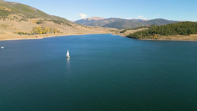 High drone footage of sailboat sailing in the lake of Dillon Reservoir in Colorado, USA