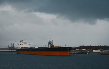 Marine Loading Arm And Crude Oil Carrier Tanker In The Harbour Engaged In Cargo Operations. © I am from Mykolayiv