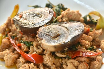 slice boiled  black preserved egg dressing spicy fried chop chicken meat and basil leaf on plate