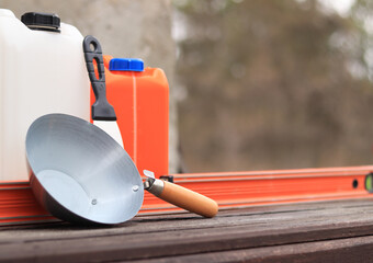Construction or plastering ladle, a spatula, a construction level and a container for primer....