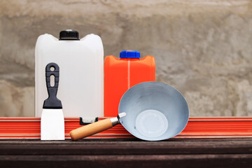 Construction or plastering ladle, a spatula, a construction level and a container for primer....
