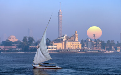 Felucca Sailboats on River Nile -   Famous egyptian TV Tower at sunset - Cairo, Egypt 
