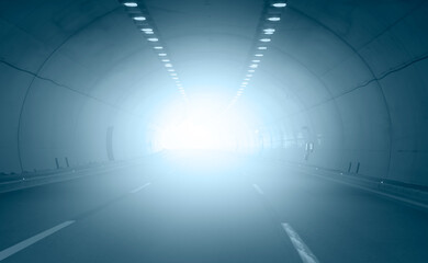 Highway road tunnel with sun light