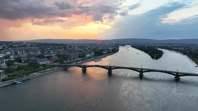 Ascending drone footage of Theodor Heuss Bridge and Mainz city on Rhine River at sunset, Germany
