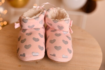 Warm indoor slippers with a cute heart design for winter comfort.