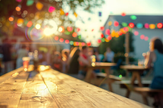 Empty wooden table in sunlight and blurred image of people at the summer street food festival. 