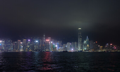 Hong Kong, China : panoramic night shot of Honk Kong from the Tsim Sha Tsui Promenade. Illuminated skyscrapers.