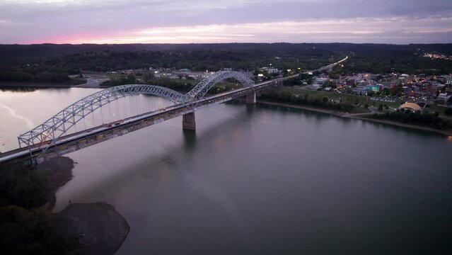 Drone footage of Sherman Minton Bridge spanning the Ohio River at sunset in Indiana, USA