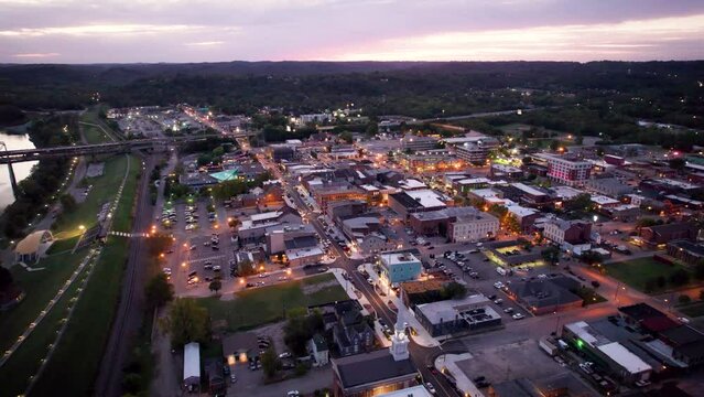 Drone footage of New Albany cityscape along Ohio River at sunset in Indiana, United States