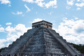 Chichén-Itzá, Yucatan Mexico - December 28 2021: Tourists walk near the Mayan pyramids in Chichen...