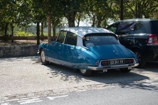 rear of a classic blue Citroen DS parked on the street in France