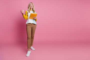 Photo of lovely cute successful woman presenting information about novelty product empty space isolated on pink color background