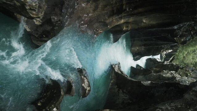 Drone footage over the Soca River glacier water flowing between rocky gorge during daytime, Slovenia
