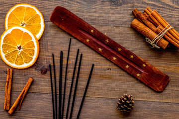 incense sticks with citrus for fresh air on wooden background top view