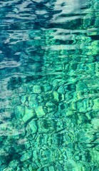 Vertical shot of the pristine, crystal-clear waters of Mgarr ix-Xini, Gozo