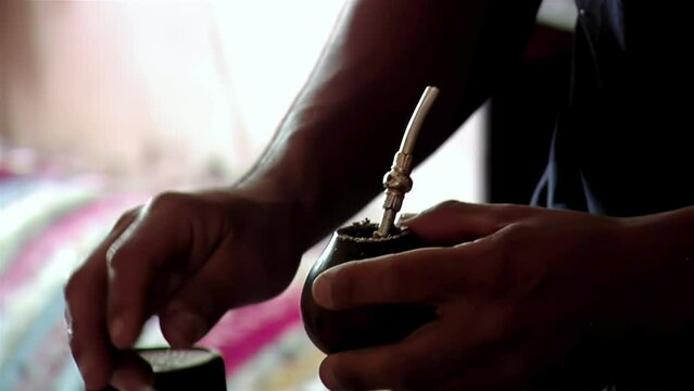 A Man Preparing a Yerba Mate Infusion at His Home in Argentina. Close Up. 