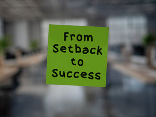 Post note on glass with 'From Setback to Success'.