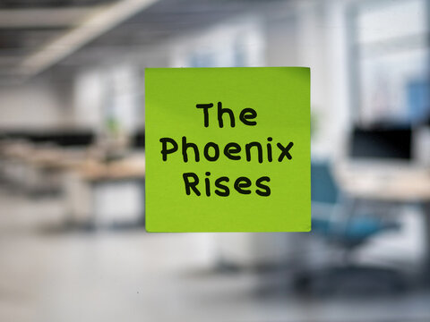 Post note on glass with 'The Phoenix Rises'.