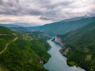 Fototapeta na wymiar Aerial view of Lake Piva winding under lush mountains in Montenegro