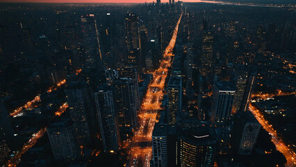 Sprawling cityscape at twilight from drone 16:9 with copy space