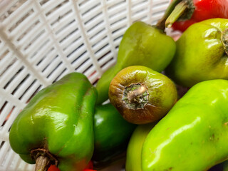 The large red and green chilies look fresh in the basket