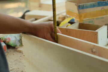 Carpenter working in workshop. carpenter measuring using pencil and ruler.