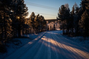 Majestic winter scene of a snow-covered landscape illuminated by a spectacular sunset sky.