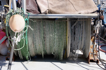 Rolled up fishing net and buoy on a trawler