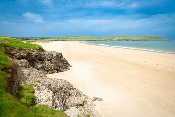 Calm beach with golden sand and a turquoise ocean