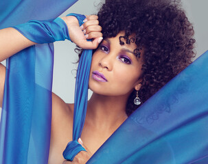 African woman, blue fabric and beauty with hands in studio for cosmetics, femininity and elegance....