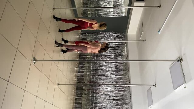 women and pylon. women in fitness clothes. vertical video. slow motion video. High-quality shooting in 4K