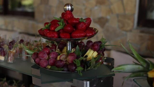 Fresh fruit platter with strawberries, grapes, and pineapple, beautifully arranged for a banquet or buffet