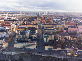 Naklejka premium Aerial view of Stockholm, Södermalm district. Katarina church, Globen and historical buildings after a rainstorm, early spring. Sunshine, partly cloudy.