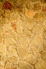 A solid beige colored stone wall suitable for the background.