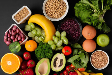 Concept of healthy food Fresh fruits, vegetables, and legumes against a black backdrop - 37