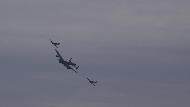 Avro Lancaster bomber world war 2 plane spitfire and Hawker Hunter in formation in the sky. Flying close to camera England UK 4K