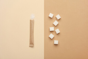 Disposable paper craft sticks with sugar cubes on a beige background