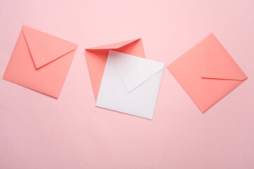 Square paper pink and white envelopes on pink background