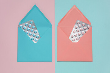 Envelopes with blisters of tablets on a blue-pink background