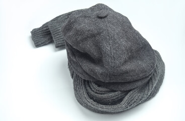 Vintage woolen English eight-piece cap with scarf on a white background. Gentleman's accessories