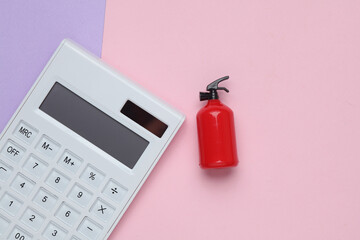 Calculator with Toy extinguisher on a pastel background. Top view