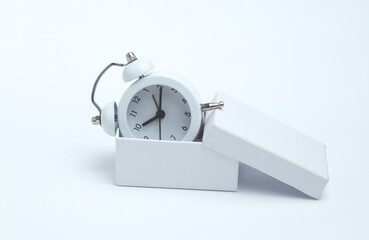 Alarm clock in box on a white background