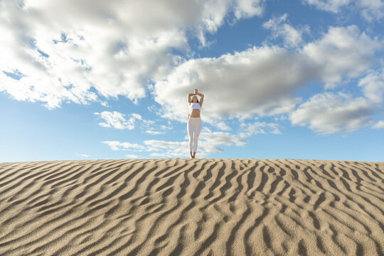 woman practicing yoga in the desert